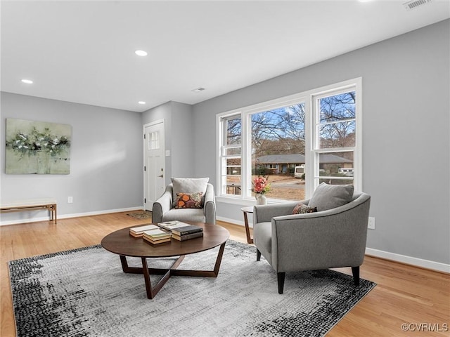 sitting room with light wood-style flooring, baseboards, and recessed lighting