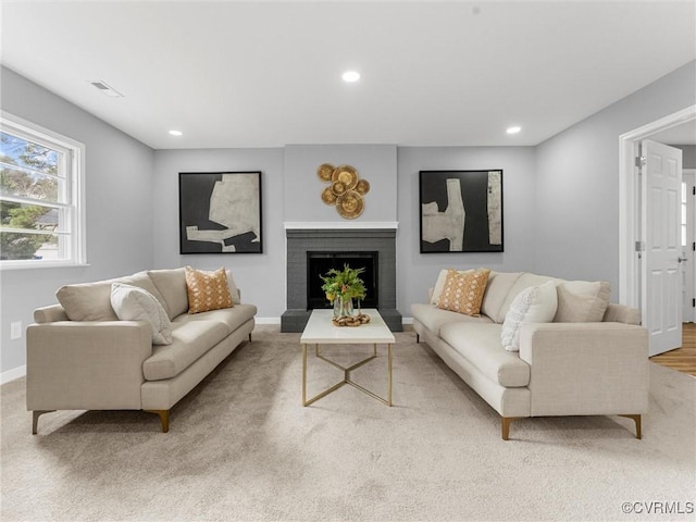 living room with recessed lighting, a brick fireplace, visible vents, and baseboards