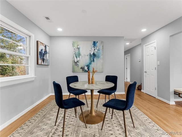 dining room featuring light wood-style floors, visible vents, baseboards, and recessed lighting