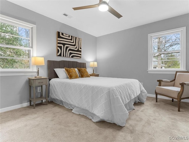 bedroom with carpet floors, visible vents, and baseboards