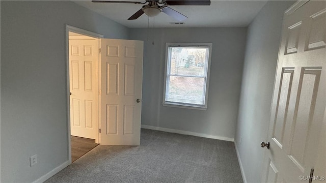 unfurnished bedroom with carpet flooring, ceiling fan, visible vents, and baseboards