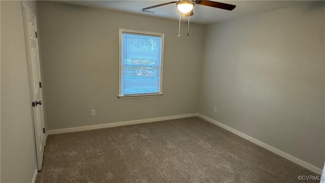 carpeted spare room featuring visible vents, ceiling fan, and baseboards