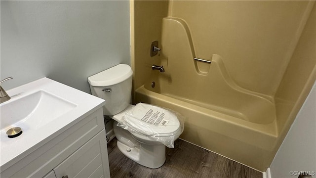 full bath featuring toilet,  shower combination, wood finished floors, and vanity