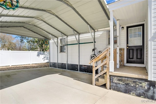 exterior space with driveway, fence, and a carport