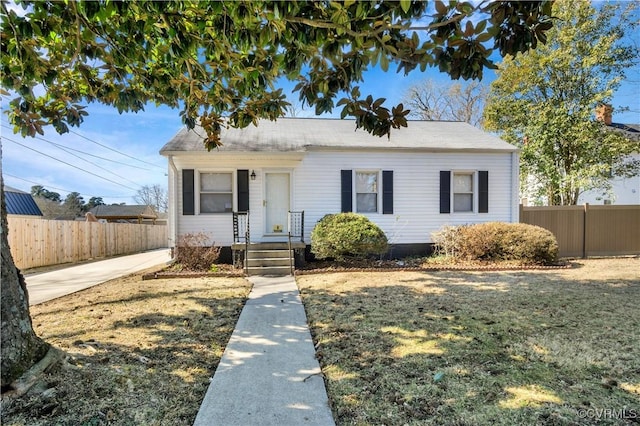 bungalow-style home with fence