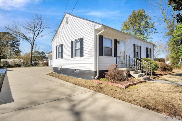 view of side of property with concrete driveway