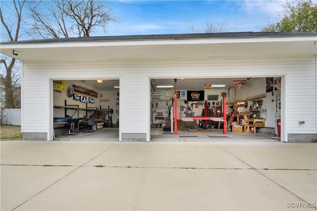 garage featuring concrete driveway