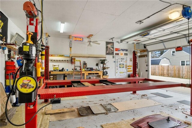 garage featuring a ceiling fan and a workshop area