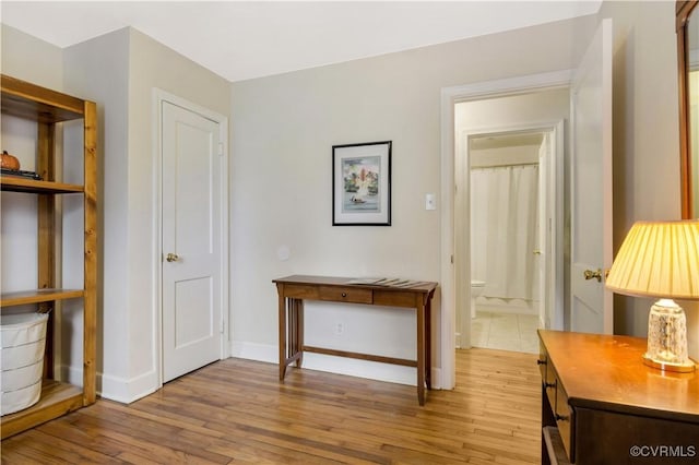 interior space featuring light wood-style floors and baseboards