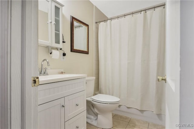 full bath with shower / bath combo, vanity, toilet, and tile patterned floors