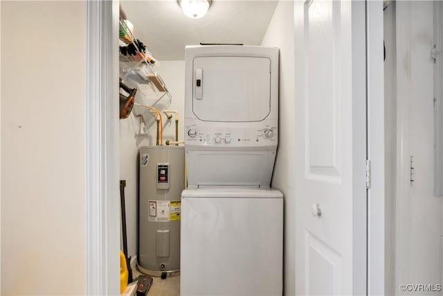 laundry room featuring laundry area, stacked washer and dryer, and electric water heater