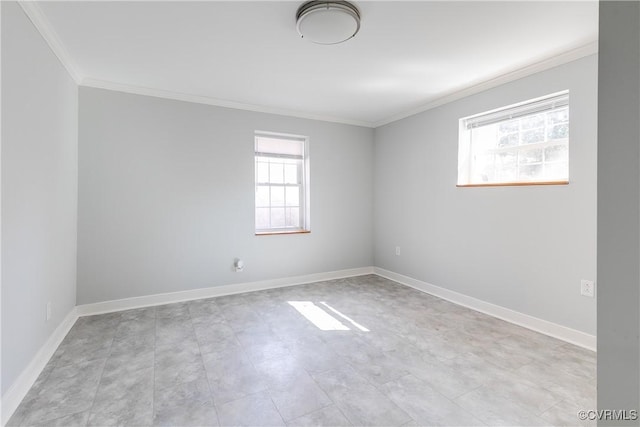 spare room with ornamental molding, plenty of natural light, and baseboards