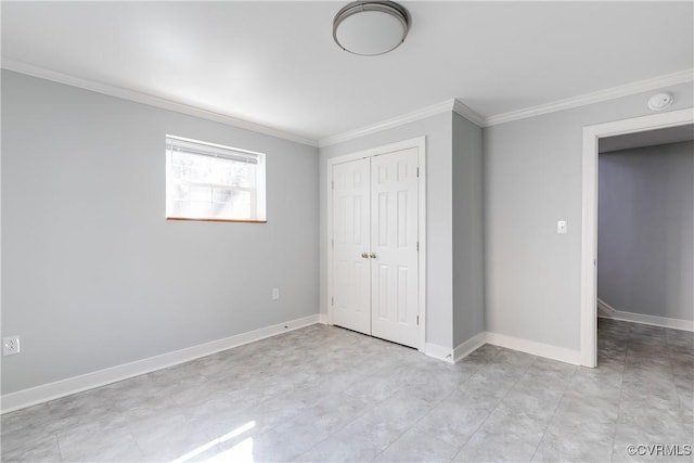 unfurnished bedroom featuring baseboards, a closet, and crown molding