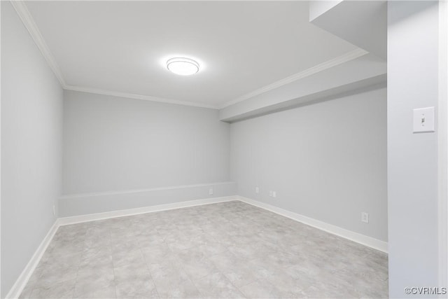 spare room featuring baseboards and ornamental molding