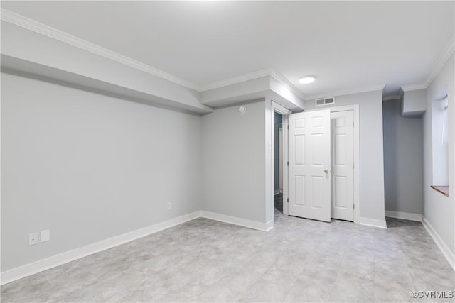 basement with visible vents, crown molding, and baseboards