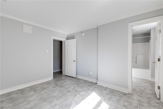 unfurnished bedroom with baseboards, a walk in closet, and crown molding