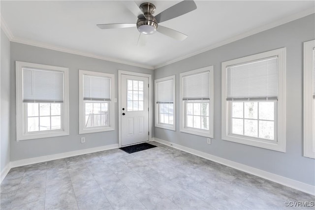 unfurnished sunroom featuring a ceiling fan and a wealth of natural light