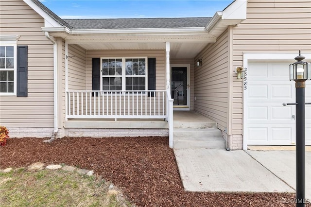 property entrance with a shingled roof and an attached garage