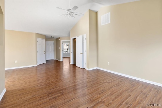 spare room featuring baseboards, visible vents, dark wood finished floors, and a ceiling fan