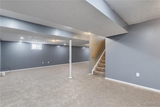 below grade area featuring carpet, stairway, baseboards, and a textured ceiling