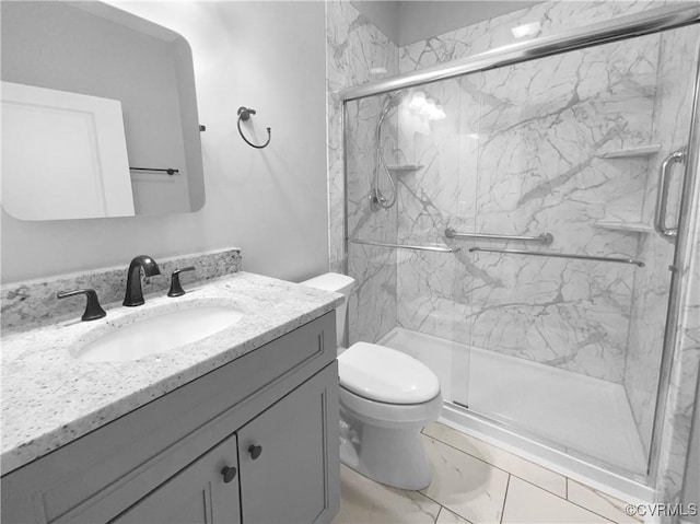 full bath featuring toilet, marble finish floor, a marble finish shower, and vanity