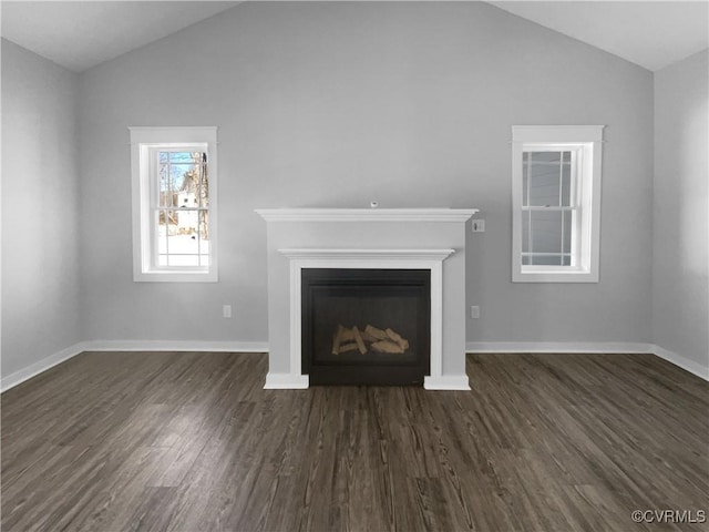 unfurnished living room featuring lofted ceiling, dark wood-style flooring, a fireplace, and baseboards