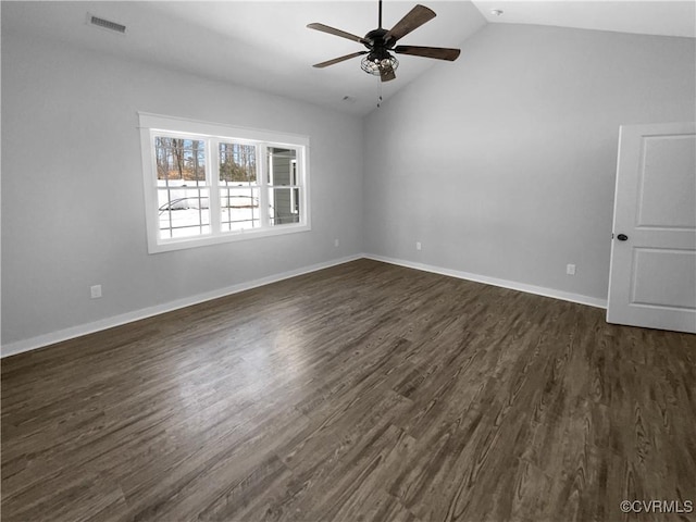 empty room featuring baseboards, visible vents, ceiling fan, dark wood-style flooring, and vaulted ceiling