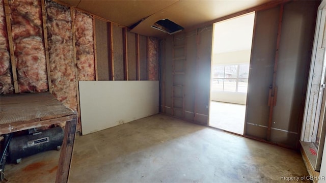 misc room with unfinished concrete flooring