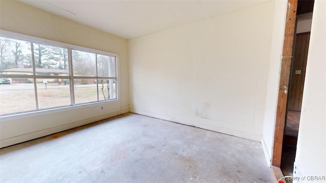 spare room featuring unfinished concrete flooring