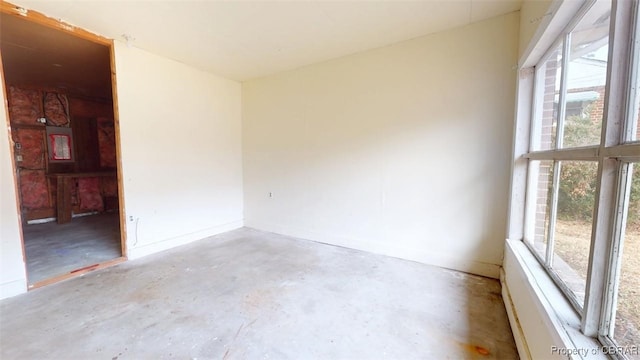 empty room featuring unfinished concrete flooring