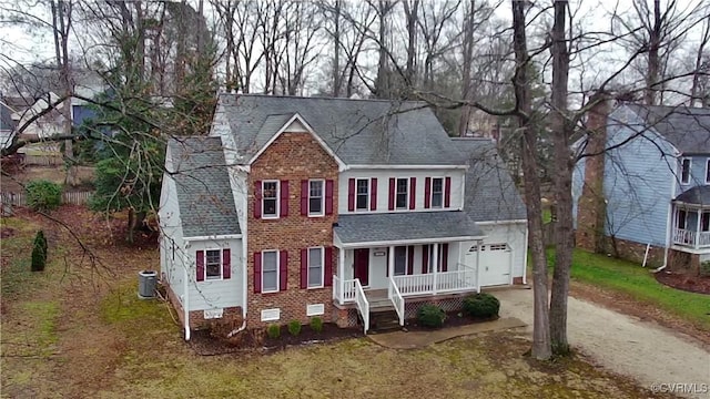 view of front of home with dirt driveway, roof with shingles, crawl space, a porch, and brick siding