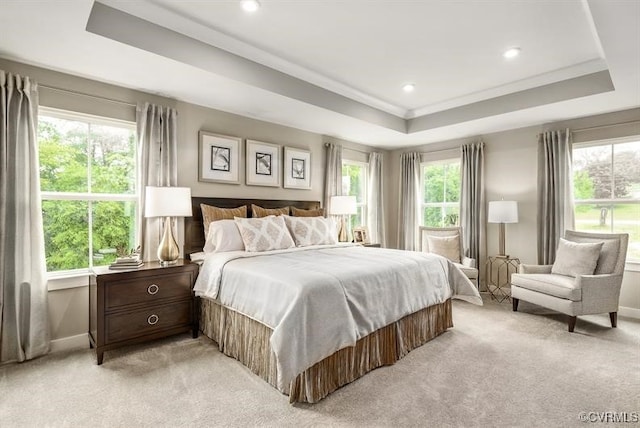 bedroom with baseboards, recessed lighting, a raised ceiling, and light colored carpet