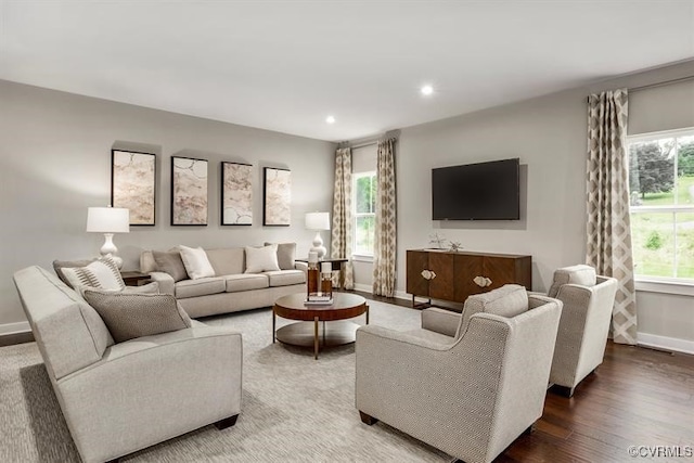 living area featuring recessed lighting, baseboards, and wood finished floors