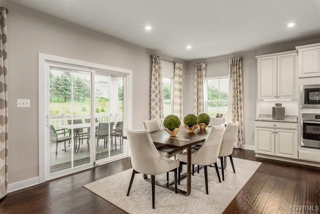 dining area with dark wood-style floors, baseboards, and recessed lighting