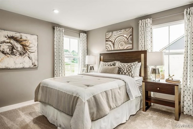 bedroom featuring light carpet and baseboards