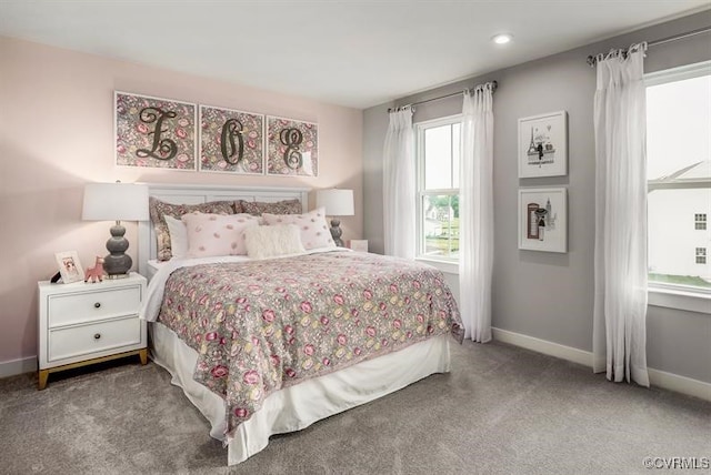 bedroom with baseboards and light colored carpet