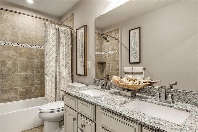 bathroom featuring shower / tub combo with curtain, a sink, toilet, and double vanity