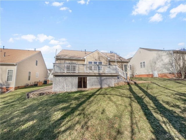 rear view of house featuring a deck, a lawn, and a residential view