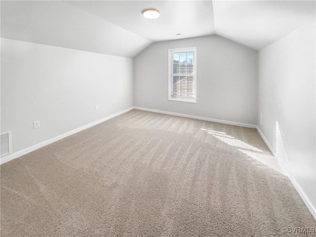 bonus room with carpet, visible vents, baseboards, and vaulted ceiling