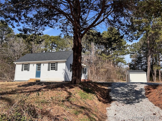 view of front of house featuring an outbuilding and roof with shingles