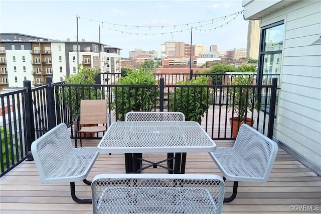 balcony featuring a view of city and outdoor dining space