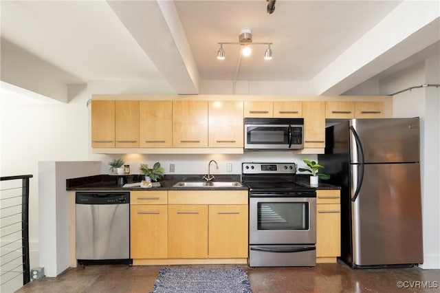 kitchen featuring appliances with stainless steel finishes, rail lighting, light brown cabinets, and a sink