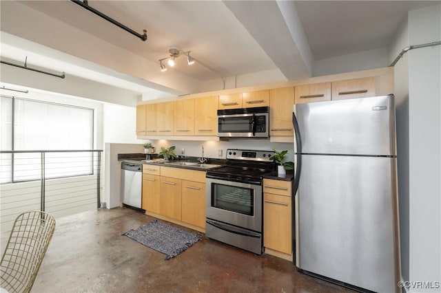 kitchen featuring stainless steel appliances, dark countertops, concrete flooring, and light brown cabinetry