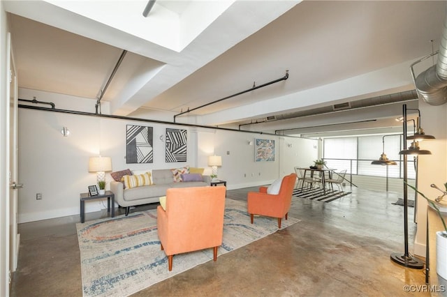 living area with concrete floors and baseboards