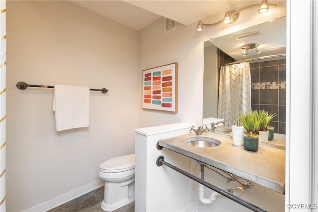 bathroom featuring baseboards, visible vents, a sink, and toilet