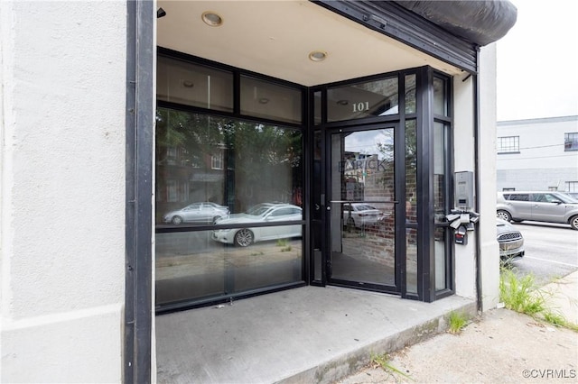 doorway to property featuring stucco siding