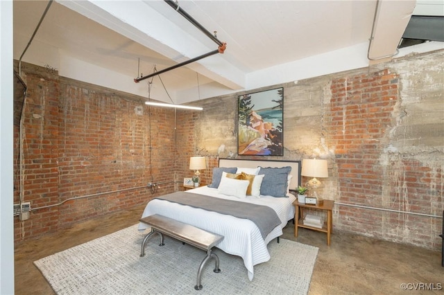 bedroom with brick wall and concrete floors