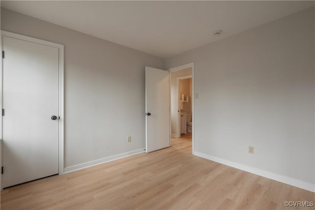 unfurnished bedroom featuring light wood-type flooring and baseboards