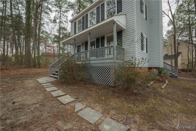 view of front of home featuring a porch and stairway