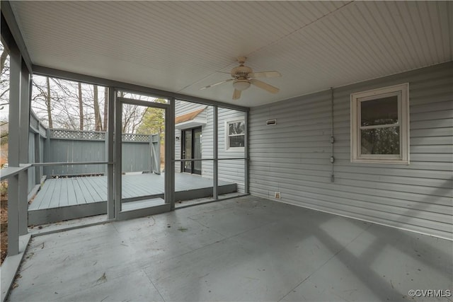 unfurnished sunroom featuring a ceiling fan